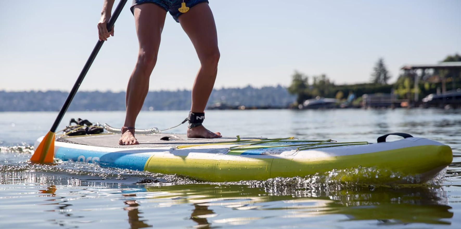 Paddle board rider making a gentle turn on calm water